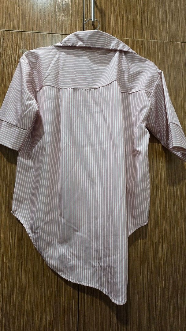 Pink and White Striped shirt (Category: Blouses) located in Cebu City. Submitted by kitty_12345_ (Listing ID 1465857010, Image 2). Description: - Color/Pattern: Pink and white vertical stripes - Size: L - Design: Button-down, collar neckline, folded sleeve cuffs, and curved hem - Material: Lightweight and comfortable fabric - Style: Casual everyday top, easy to pair with jeans or skirts MOP: gcash, mari, maya, gotyme MOD: Lbc Meetup: Parkmall.