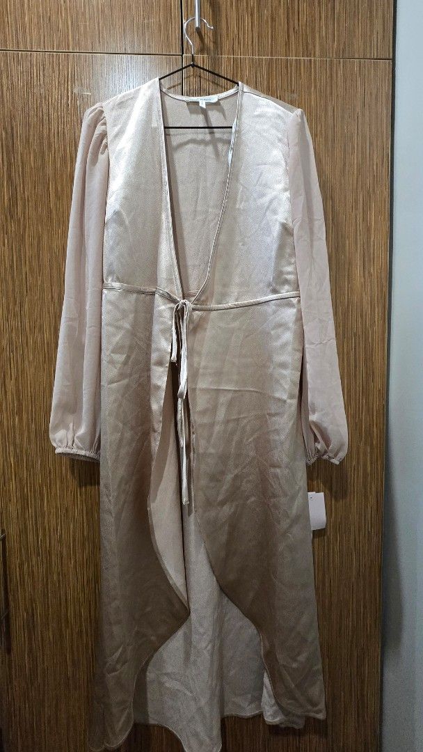 Biege satin wrap midi dress (Category: Dresses) located in Cebu City. Submitted by kitty_12345_ (Listing ID 1465907810, Image 3). Description: - Style: biege satin wrap dress - Details: Long sheer sleeves with gathered cuffs and matching waist tie - Condition: Brand new with tag still attached MOP: gcash, mari, maya, gotyme MOD: Lbc, maxim Meetup: Parkmall.