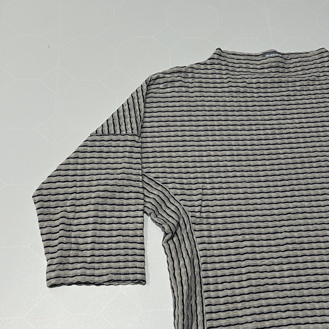 Plantation Grey Black Striped Textured Top (Category: Blouses) located in Caloocan City. Submitted by lostarchive_55 (Listing ID 1465915406, Image 3). Description: - Brand: A-net Inc. (Made in Japan) - Color/Pattern: Plantation grey and black striped - Size: Medium (M) - Material: 77% cotton, 23% polyester (lightweight, stretchy textured fabric) - Design: Boat neckline, 3/4 sleeves, relaxed boxy cut, and vertical ribbed side panels.