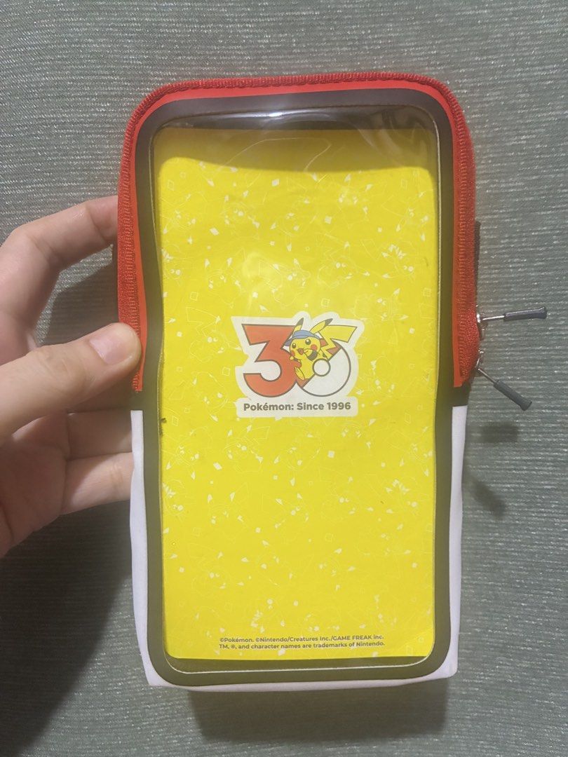 Pokemon Mobile Armband (Category: Cases & Sleeves) located in Rizal. Submitted by melowfashion_preloved (Listing ID 1465893582, Image 1). Description: Location: Rizal - Official-style Pokémon design featuring Pikachu and Poké Ball colors (red, white, yellow, black) - Clear touch-sensitive front window for easy phone access while working out - Breathable black mesh backing for comfortable wear during runs or exercise - Adjustable Velcro strap for 