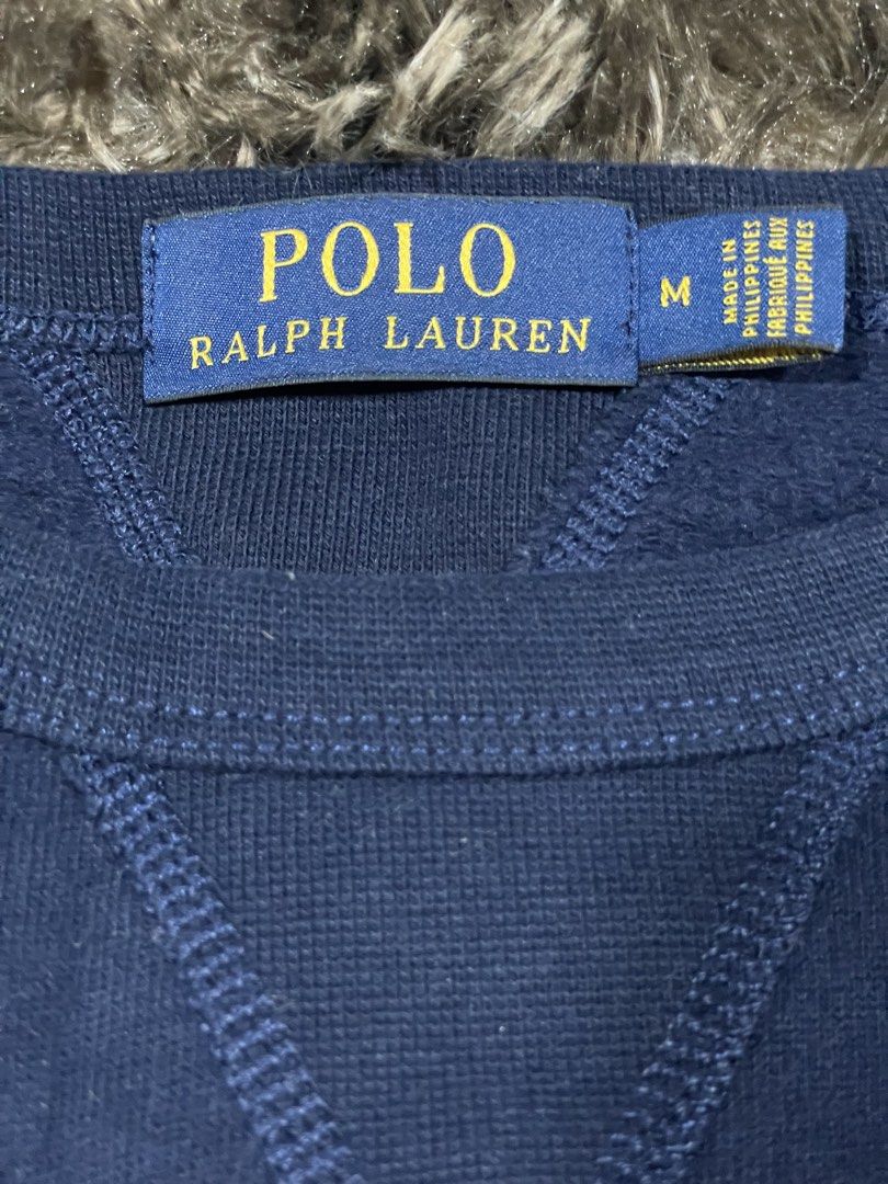 Polo Ralph Lauren Bear (Category: Coats, Jackets and Outerwear) located in Calapan. Submitted by lucasthrifts (Listing ID 1465887664, Image 2). Description: - Brand: Polo Ralph Lauren - Style: Crewneck sweatshirt with V-stitch detail - Color: Navy blue - Design: Iconic Polo Bear graphic on the chest - Size: Medium (tag inside collar) Fits up to Large - Material: Comfortable cotton and polyester blend - Ribbed collar, cuffs, and hem -Condition: Ex
