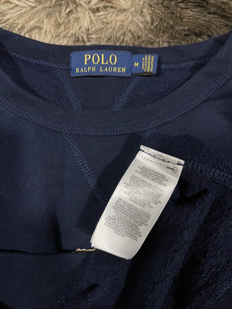 Polo Ralph Lauren Bear (Category: Coats, Jackets and Outerwear) located in Calapan. Submitted by lucasthrifts (Listing ID 1465887664, Image 3). Description: - Brand: Polo Ralph Lauren - Style: Crewneck sweatshirt with V-stitch detail - Color: Navy blue - Design: Iconic Polo Bear graphic on the chest - Size: Medium (tag inside collar) Fits up to Large - Material: Comfortable cotton and polyester blend - Ribbed collar, cuffs, and hem -Condition: Ex