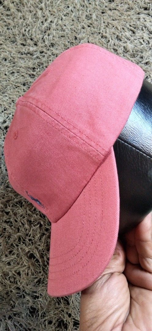 Polo Ralph Lauren Pink Baseball Cap AUTHENTIC (Category: Activewear) located in Paranaque City. Submitted by michael-08 (Listing ID 1465886920, Image 3). Description: - Brand: Polo Ralph Lauren - Color: Pink with blue accents - Design: Classic six-panel construction with embroidered eyelets - Details: Embroidered blue pony logo on the front and "POLO" embroidery on the back - Fit: Adjustable strap with a metal buckle slider for a custom fit - Con