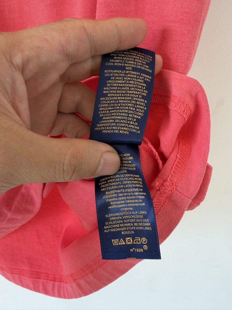 Polo Ralph Lauren Pink Tee (Category: Shirts) located in Quezon City. Submitted by satisfied_buyer (Listing ID 1465763393, Image 3). Description: - Brand: Polo Ralph Lauren - Style: Crewneck t-shirt - Color: Pink with blue embroidered pony logo - Size: XL - Material: 100% Cotton - Condition: Clean with standard wear Shoulders 47 m Chest 53m Length 73m.