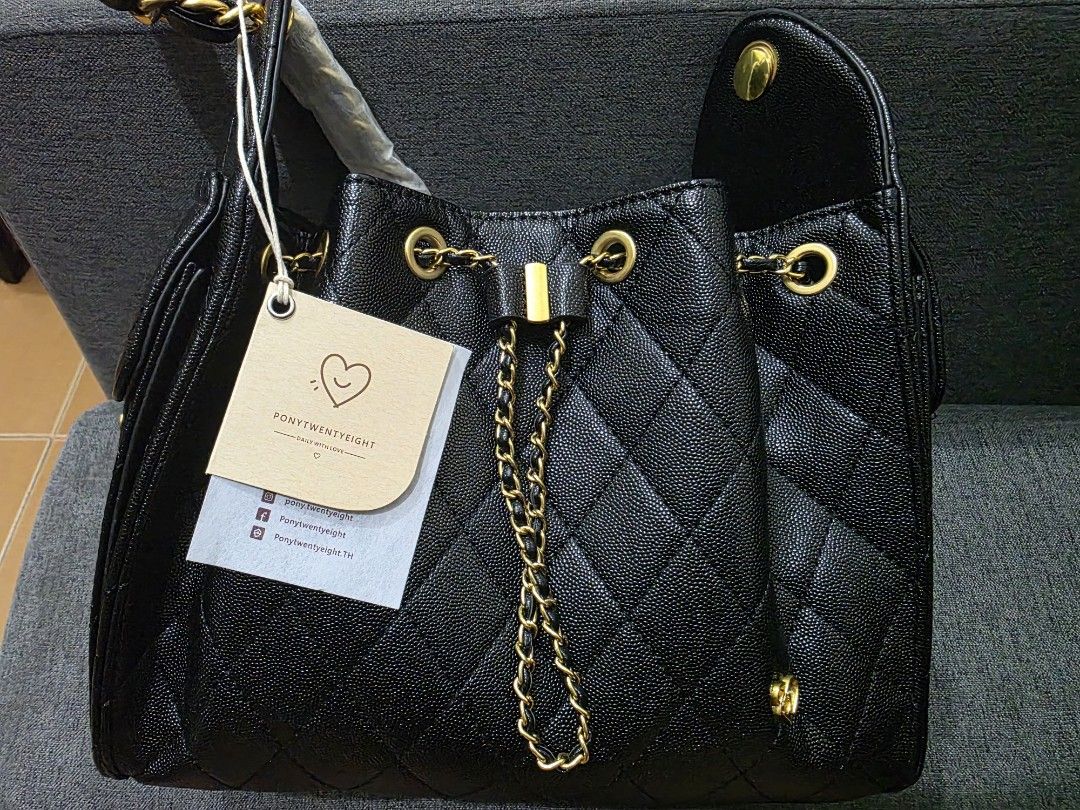 Pony Twenty Eight Deco Large (Category: Luxury Bags & Wallets) located in Pasig City. Submitted by shengshenge (Listing ID 1465860183, Image 2). Description: - Brand: Pony Twenty Eight Deco Large - Style: Black quilted bucket bag with structured sides and snap details ; Ch@nel 25 inspired - Hardware: Elegant gold-tone chain and metal accents - Closure: Drawstring closure - Condition: Brand new with tag still attached to the strap - Inclusions: Co