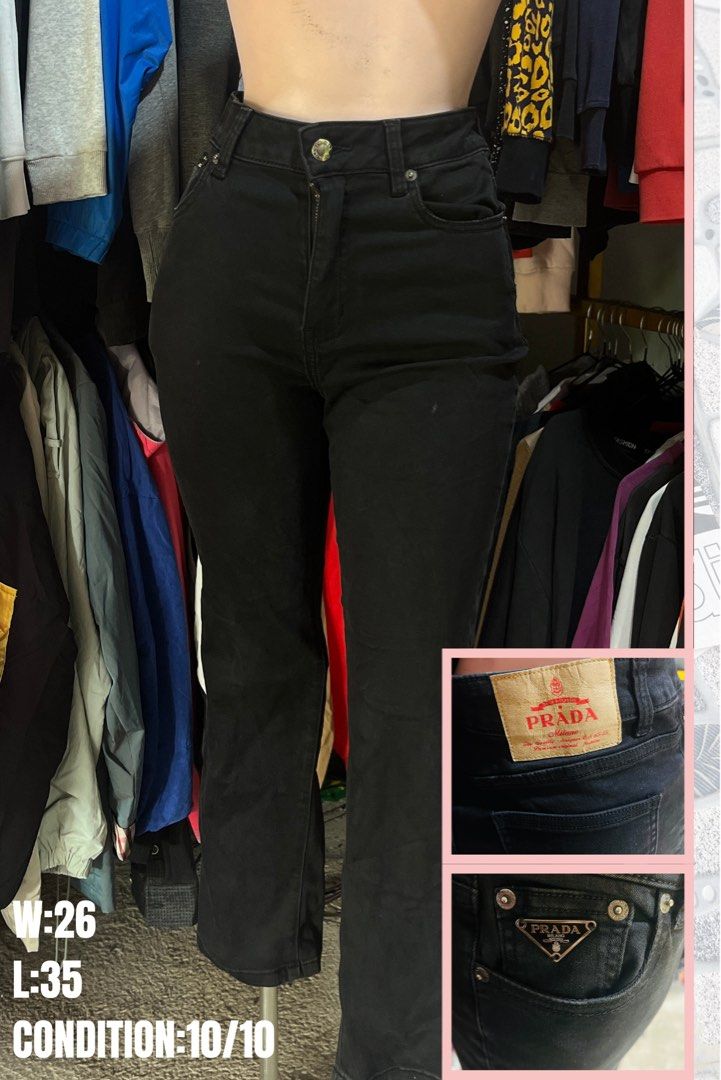 Prada Black Jeans W:26 L:35 (Category: Jeans) located in Brookes Point. Submitted by grandfish.2f86fc (Listing ID 1465766745, Image 1). Description: - Brand: Prada - Color: Solid black wash - Fit: High waist with straight legs - Size: Waist 26 inches, Length 35 inches - Details: Branded leather patch on the back and metallic logo hardware on the front pocket - Condition: Clean and well-maintained.