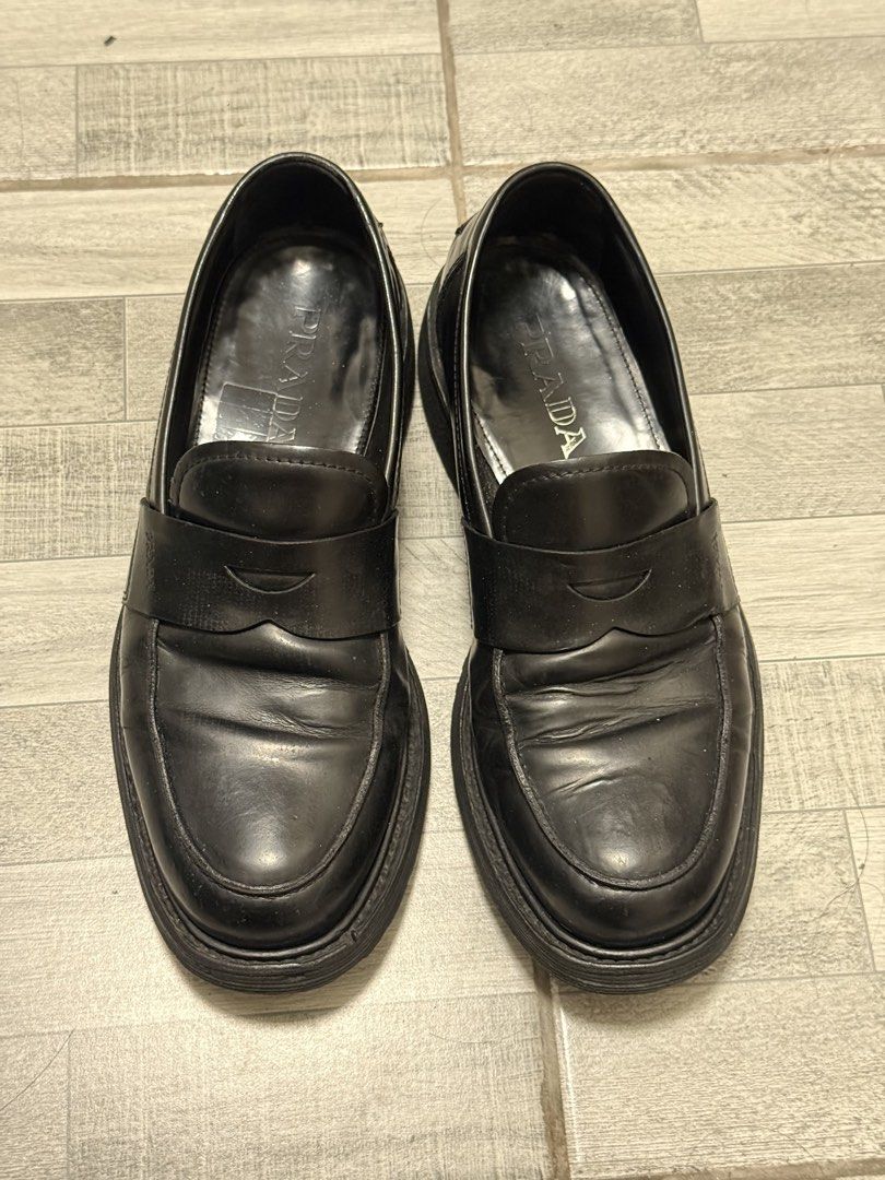 Prada Black Leather Penny Loafers (Category: Dress Shoes) located in Manila. Submitted by c_archive (Listing ID 1465896598, Image 1). Description: Prada black leather penny loafers. Natural creasing across the leather vamp from regular wear. Outsole re-stitched in Mr. Quickie.