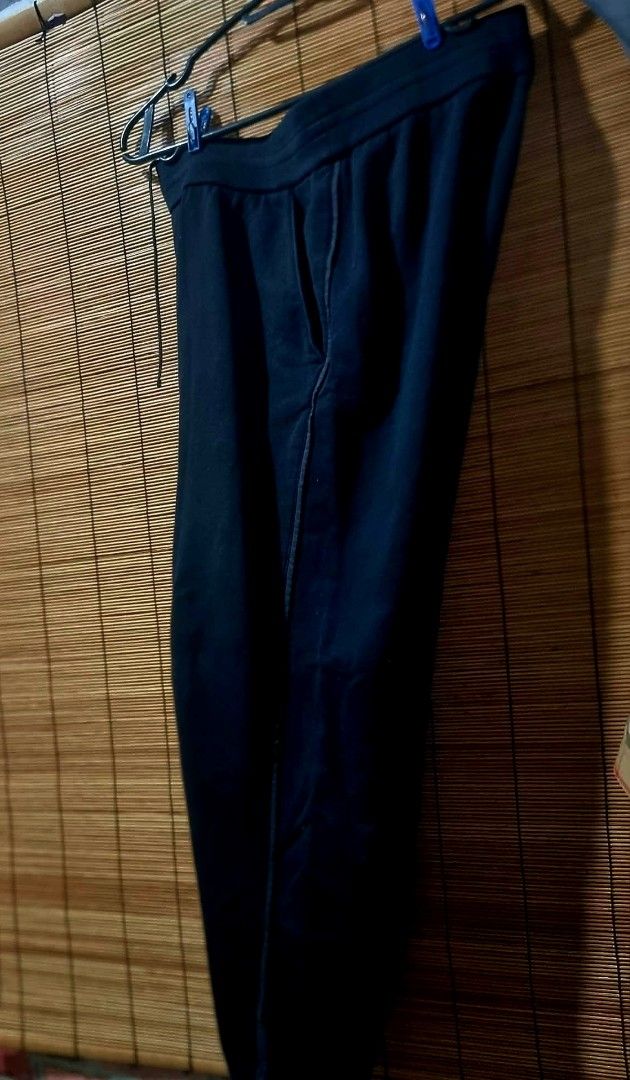 Prada Black Sweatpants with Pocket and Ankle Zips (Category: Joggers) located in Legazpi City. Submitted by rhumbalagu04057 (Listing ID 1465800423, Image 3). Description: Prada black sweatpants. Elastic waistband with drawstring. Deep side pockets plus a buttoned patch pocket on the right leg featuring the red Prada logo plaque. Zippers at the ankles with branded hardware and snap buttons. Heavyweight cotton fleece material..