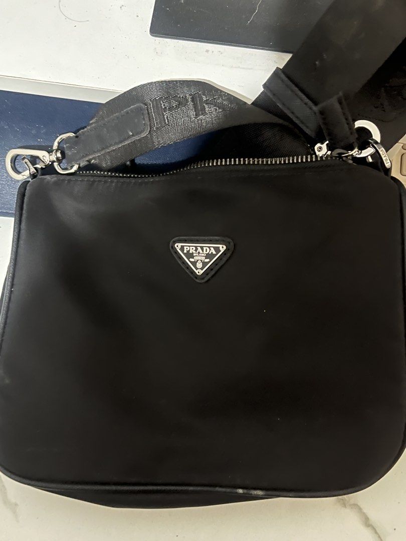 RUSH RUSH RUSH!!! Prada nylon shoulder/crossbody bag (Category: Shoulder Bags) located in Taguig. Submitted by mailipang758544 (Listing ID 1465854647, Image 2). Description: RUSH SALE!! Prada nylon shoulder/crossbody bag Condition: around 7/10 • Nylon body looks generally good • Logo plaque looks good • Prada-branded hardware is present •Interior jacquard lining is visible •Strap has noticeable wear/fraying •There are some surface marks/wear on •