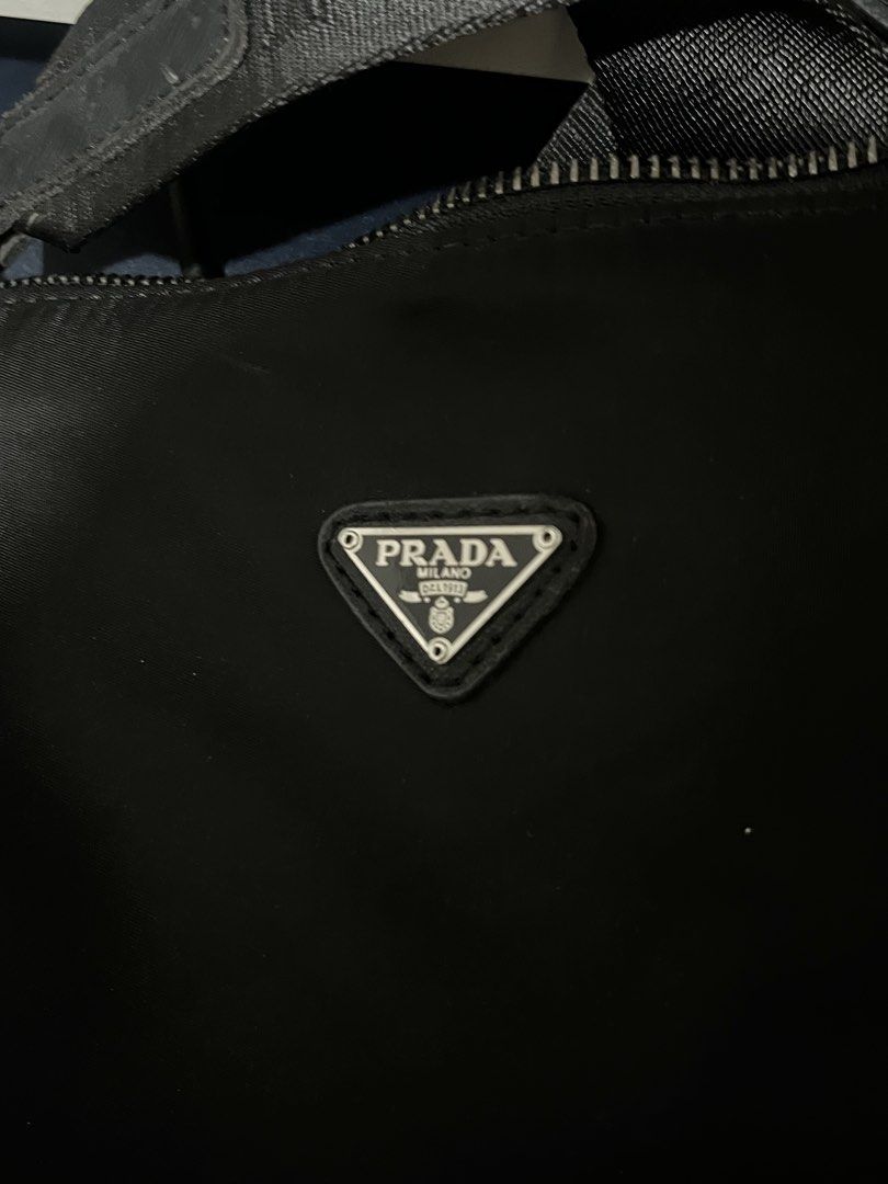 RUSH RUSH RUSH!!! Prada nylon shoulder/crossbody bag (Category: Shoulder Bags) located in Taguig. Submitted by mailipang758544 (Listing ID 1465854647, Image 3). Description: RUSH SALE!! Prada nylon shoulder/crossbody bag Condition: around 7/10 • Nylon body looks generally good • Logo plaque looks good • Prada-branded hardware is present •Interior jacquard lining is visible •Strap has noticeable wear/fraying •There are some surface marks/wear on •