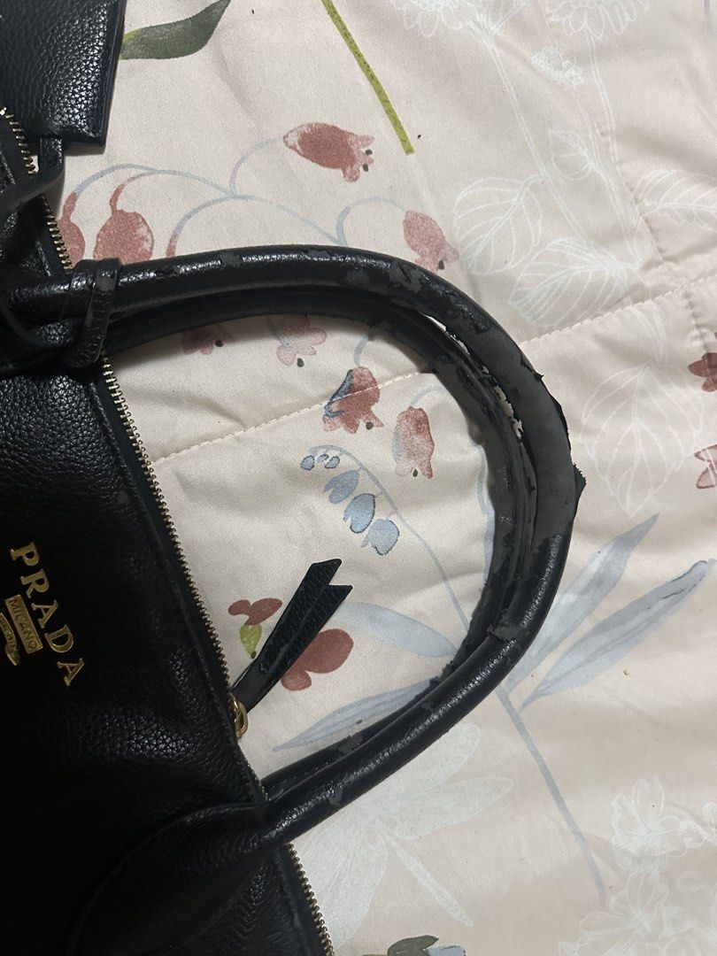 Prada Vitello Daino Small Tote (Category: Luxury Bags & Wallets) located in Makati City. Submitted by biancak20 (Listing ID 1465897347, Image 2). Description: - Brand: Prada - Material: crafted from textured calfskin leather with gold-tone hardware and dual top handles. - Features: Dual top handles, adjustable shoulder strap, signature front lettering logo, 4 protective metal feet - Interior: Black fabric lining with a secure zip compartment - Co