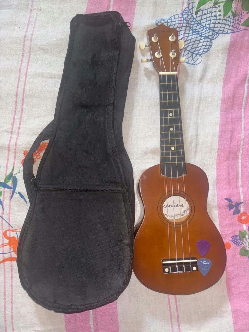 Premiere Ukulele Wooden Instrument (Category: Musical Instruments) located in Trece Martires City. Submitted by unshelved_ph (Listing ID 1465857874, Image 3). Description: Ukulele for Sale‼️ 📌Premiere Ukulele Freebies: ✅Ukulele Bag ✅2 Guitar Picks 👉Barely used (ginamit lang for a school performance) 👉In good condition 👉Scratches do not affect the instrument's performance - DM for more info - CO through DM. If shipping, it will be through J&T 
