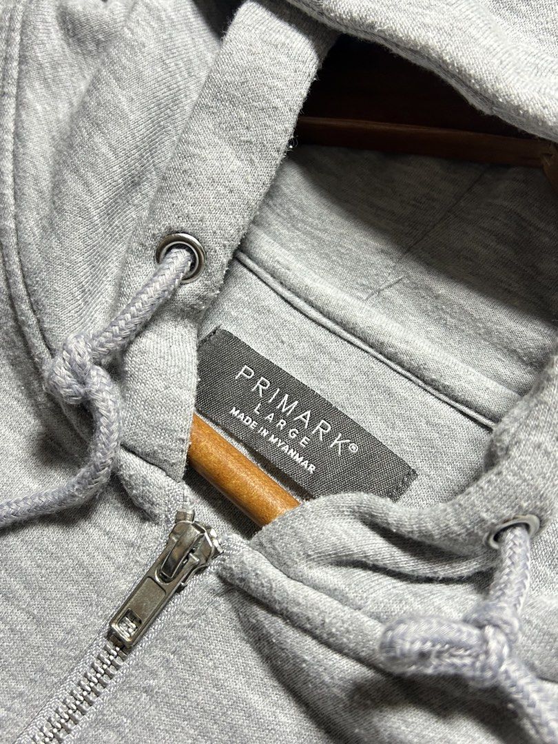 Primark Grey Zip-Up Hoodie Size L (Category: Coats, Jackets and Outerwear) located in Tarlac. Submitted by selfmade_legacy (Listing ID 1465894139, Image 3). Description: - Brand: Primark - Size: Large - Color: Classic Grey - Material: 50% cotton blend with soft fleece interior lining - Features: Front metal zipper closure, adjustable hood drawstrings with metal aglets, ribbed cuffs and hem - Condition: Great everyday basic hoodie for casual wear 