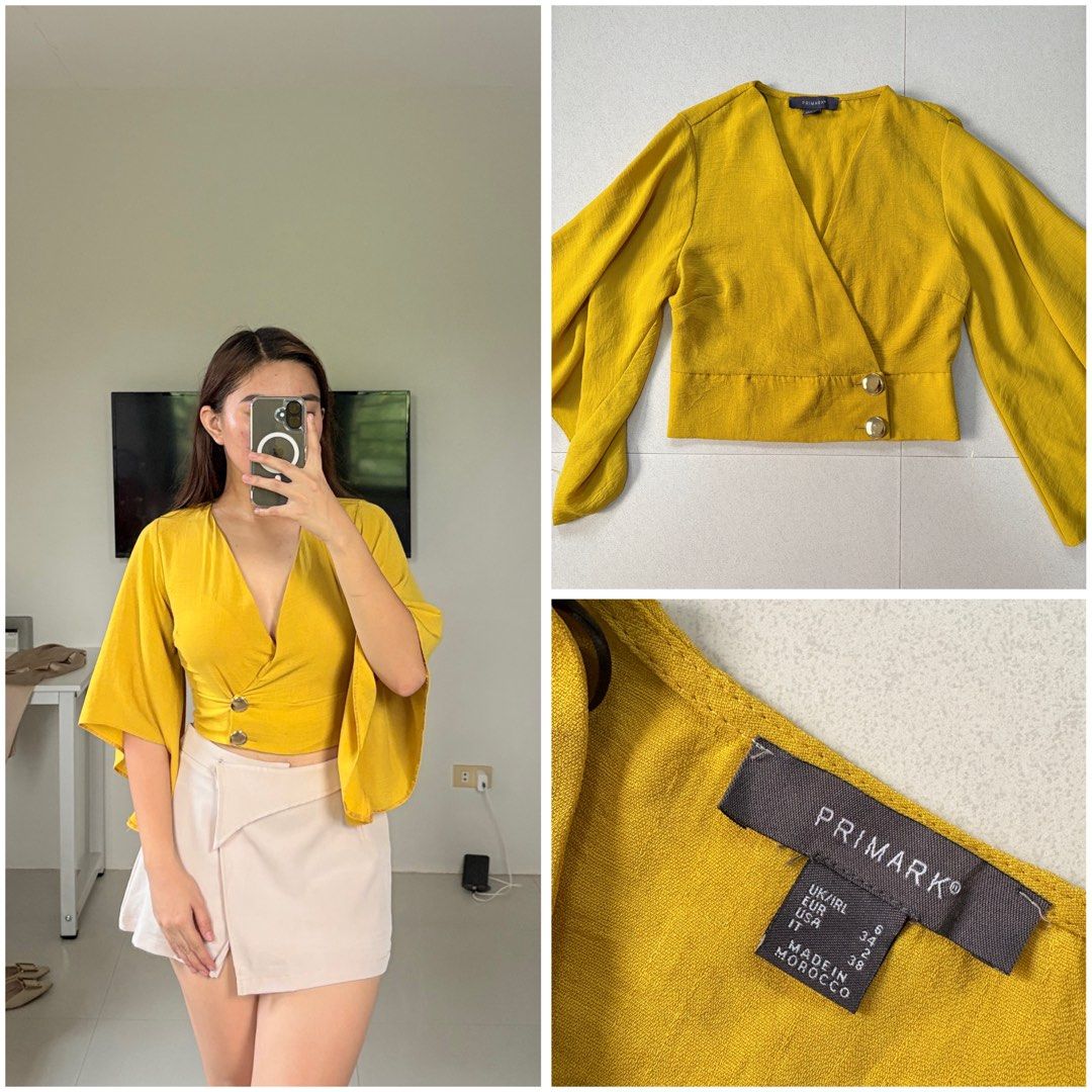 Primark Wrap Crop Top (Category: Blouses) located in San Jose. Submitted by ikonicaura (Listing ID 1465858241, Image 1). Description: - Brand: Primark - Color: Mustard yellow - Size: XS, UK 6 - Design: Wrap-style front, V-neckline, wide flared bell sleeves, and two side decorative buttons.