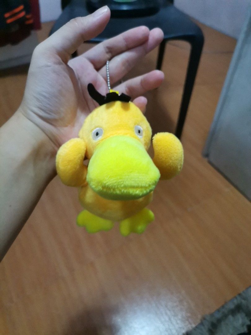 Psyduck Pokemon Plush Keychain Stuffed Toy (Category: Plushies & Soft Toys) located in Makati City. Submitted by kookybearsstuff (Listing ID 1465886548, Image 2). Description: - Adorable yellow Psyduck plush keychain - Features soft stuffed material, tiny arms holding its head, and cute black hair detail - Includes a silver ball chain for easy hanging - Clean and ready to attach to your bags or keys.