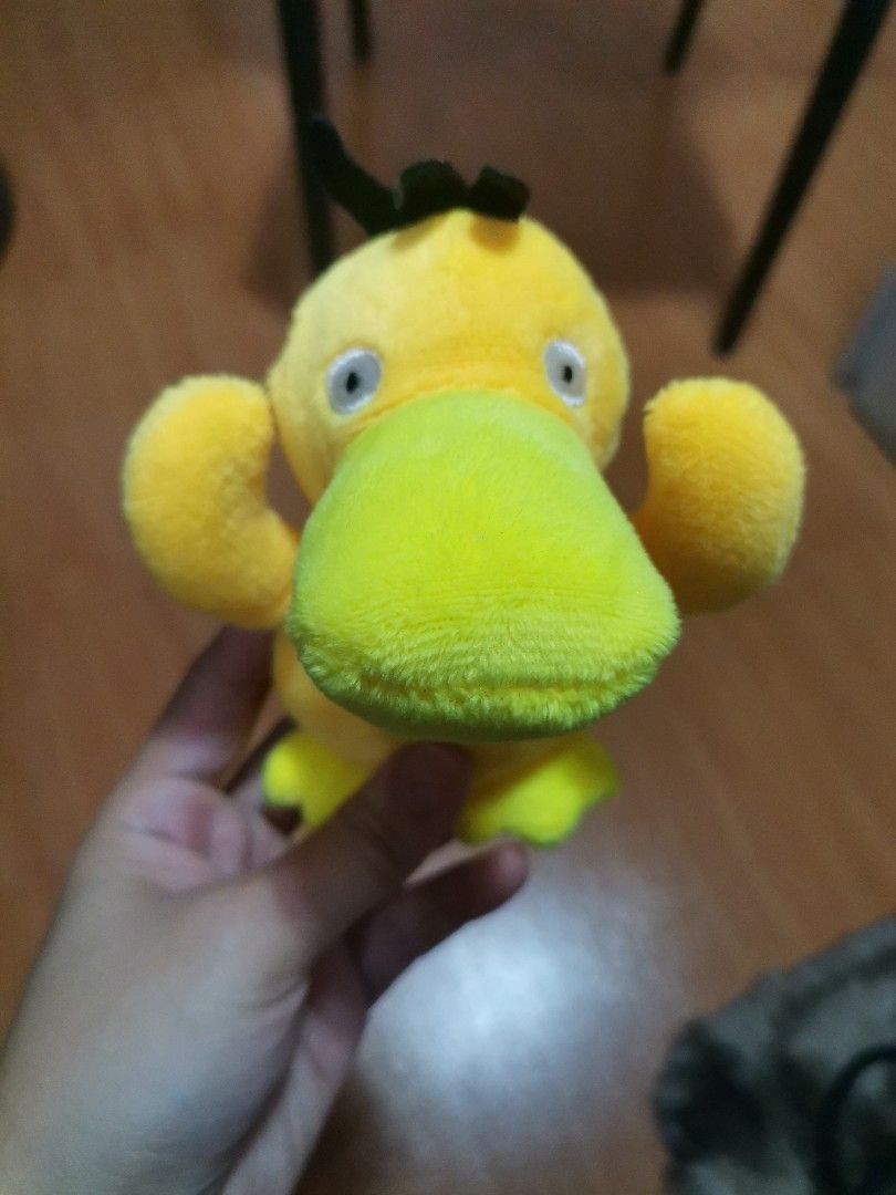 Psyduck Pokemon Plush Keychain Stuffed Toy (Category: Plushies & Soft Toys) located in Makati City. Submitted by kookybearsstuff (Listing ID 1465886548, Image 1). Description: - Adorable yellow Psyduck plush keychain - Features soft stuffed material, tiny arms holding its head, and cute black hair detail - Includes a silver ball chain for easy hanging - Clean and ready to attach to your bags or keys.