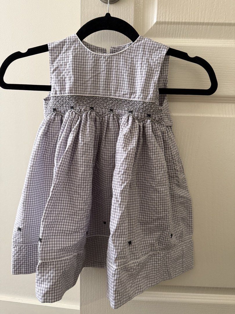 Puffy Threads PH Grey Gingham Smocked Dress Size 2 (Category: Dresses) located in Taguig. Submitted by muntingkahon (Listing ID 1465764186, Image 1). Description: - Brand: Puffy Threads PH - Size: 2 - Color/Pattern: Grey and white gingham - Details: Smocked bodice with intricate grey embroidery, white piping along neckline and hem - Cut: Sleeveless with a flared skirt - Condition: Great for casual days or special occasions.