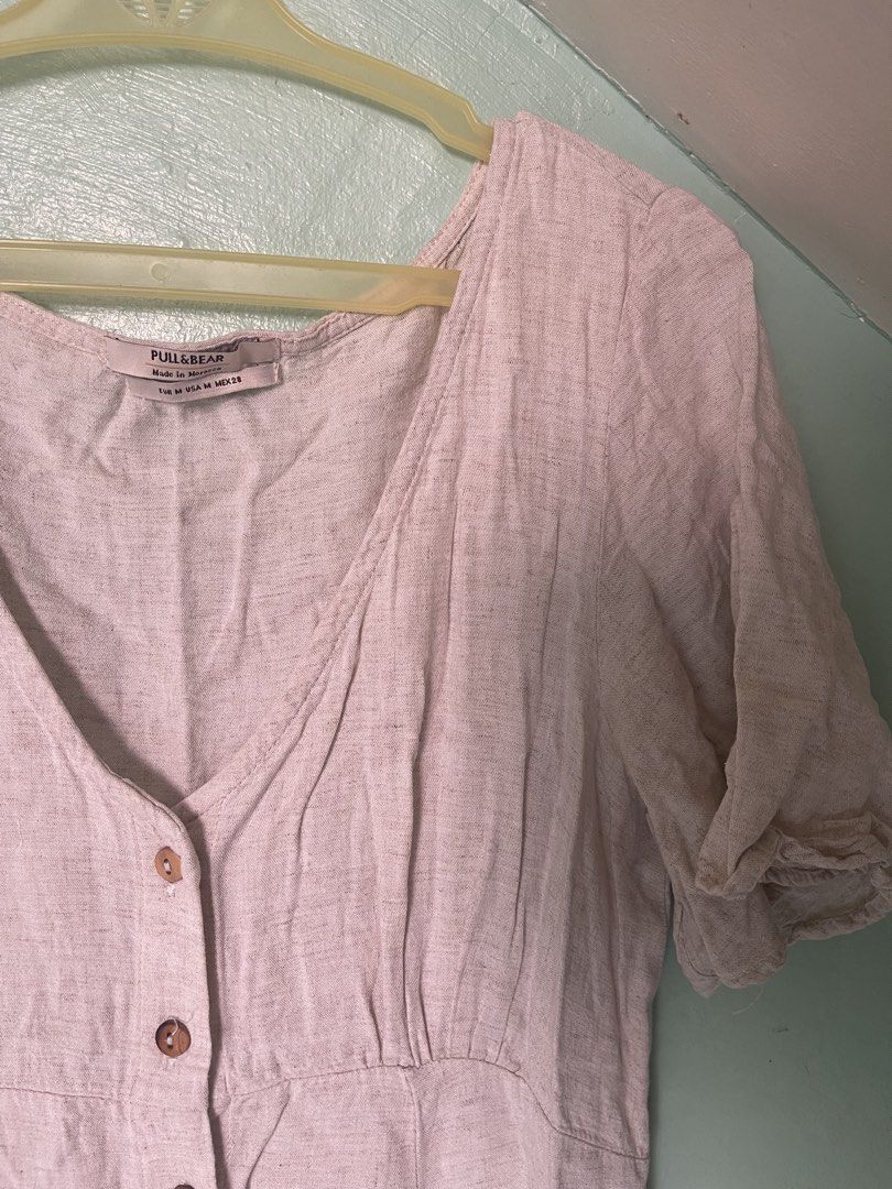 Pull & Bear Cream Midi Dress Size M (Category: Dresses) located in Baybay. Submitted by shikita27906 (Listing ID 1465841925, Image 2). Description: - Brand: Pull & Bear - Size: M (Made in Morocco) - Color: Cream with brown front buttons - Style: V-neck, short sleeves, fitted bodice, flared skirt - Material: Lightweight, breathable linen-like fabric - Condition: Great for casual everyday wear and warmer weather.