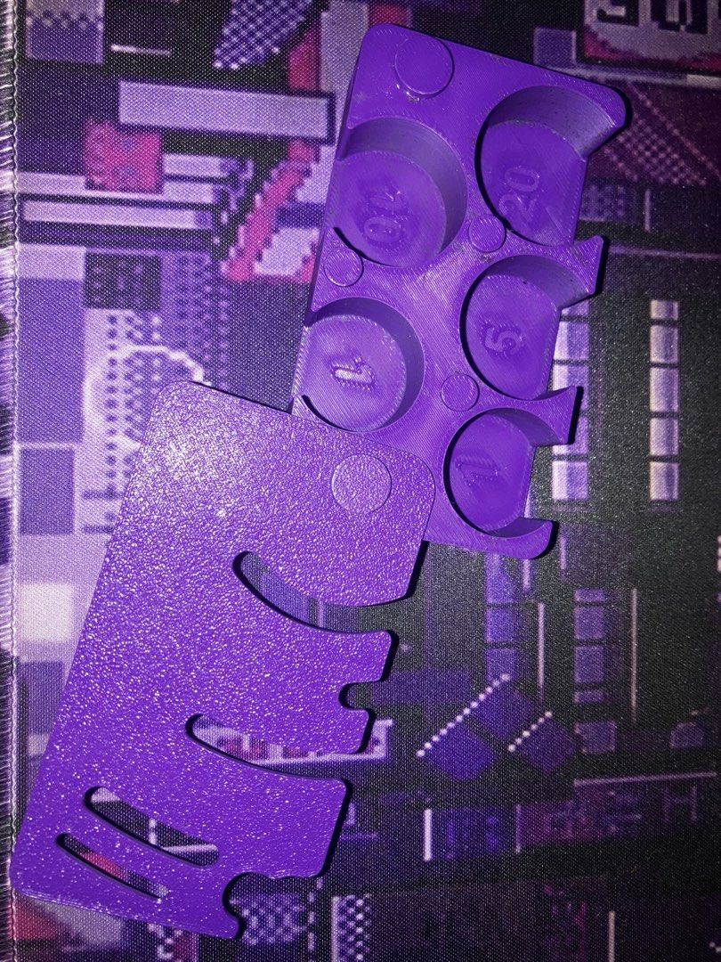 Purple 3D Printed Counter Coin Holder (Category: Wallets & Card holders) located in Manila. Submitted by yilviolet (Listing ID 1465779359, Image 1). Description: - Color: Vibrant purple with a textured exterior finish - Organized storage: Dedicated slots for 1s, 5s, 10s, and 20s damage counters and coins - Secure transport: Includes a matching slide-on lid to keep tokens safe - Portable: Compact size easily fits inside standard deck boxes or bags