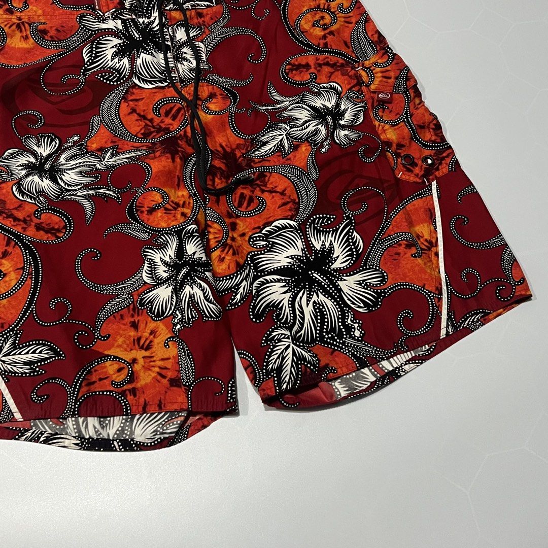 Quiksilver Men's Floral Pattern Board Shorts (Category: Swim Trunks & Board Shorts) located in Caloocan City. Submitted by lostarchive_55 (Listing ID 1465917352, Image 3). Description: - Brand: Quiksilver - Condition: Clean with tags intact - Colors: Red, orange, and black with floral/batik print - Features: Drawstring waistband with branded metal grommets, button fly, and side cargo pocket - Fit/Material: Lightweight, standard fit - Ideal for: S