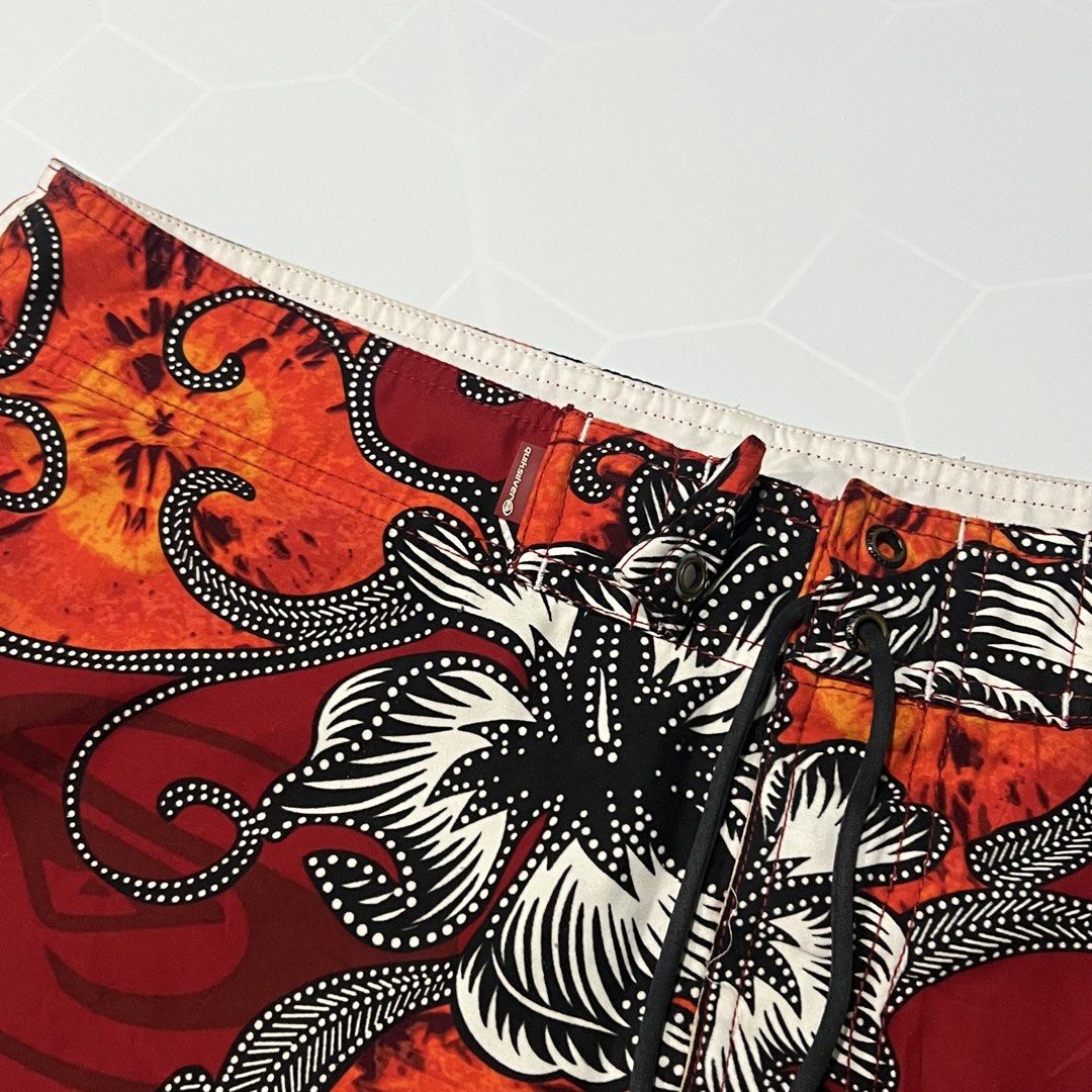 Quiksilver Men's Floral Pattern Board Shorts (Category: Swim Trunks & Board Shorts) located in Caloocan City. Submitted by lostarchive_55 (Listing ID 1465917352, Image 2). Description: - Brand: Quiksilver - Condition: Clean with tags intact - Colors: Red, orange, and black with floral/batik print - Features: Drawstring waistband with branded metal grommets, button fly, and side cargo pocket - Fit/Material: Lightweight, standard fit - Ideal for: S