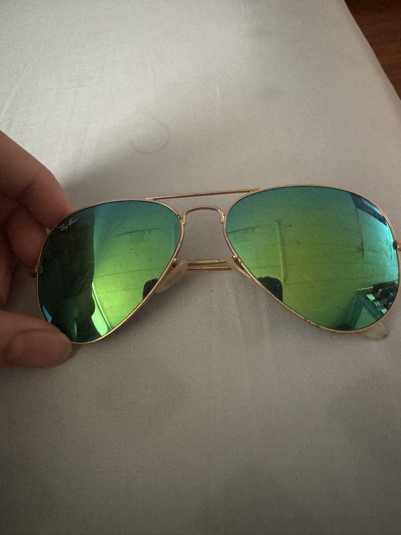 Ray-Ban Aviator Green Mirrored Sunglasses With Case (Category: Sunglasses & Eyewear) located in Manila. Submitted by jarred_inocentes (Listing ID 1465779328, Image 1). Description: - Brand: Ray-Ban - Style: Classic Aviator / Teardrop shape - Lenses: Striking green mirrored lenses - Frames: Thin gold-tone metal with comfortable nose pads and curved temples - Inclusions: Original brown textured leatherette hard case with snap closure - Condition: R