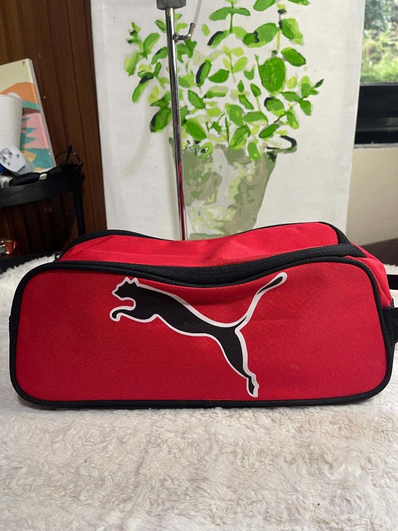 Red and Black Puma Shoe Bag (Category: Sling Bags) located in Naawan. Submitted by twilly.apparel2 (Listing ID 1465842429, Image 1). Description: - Brand: Puma - Color: Red and black - Size: Approx. 13 inches long - Material: Durable canvas with clean interior and exterior - Features: Secure zipper closure, top handle for easy carrying, and bold Puma leaping cat logo - Condition: Excellent, clean, and ready to use - Best for: Gym shoes, sports ge