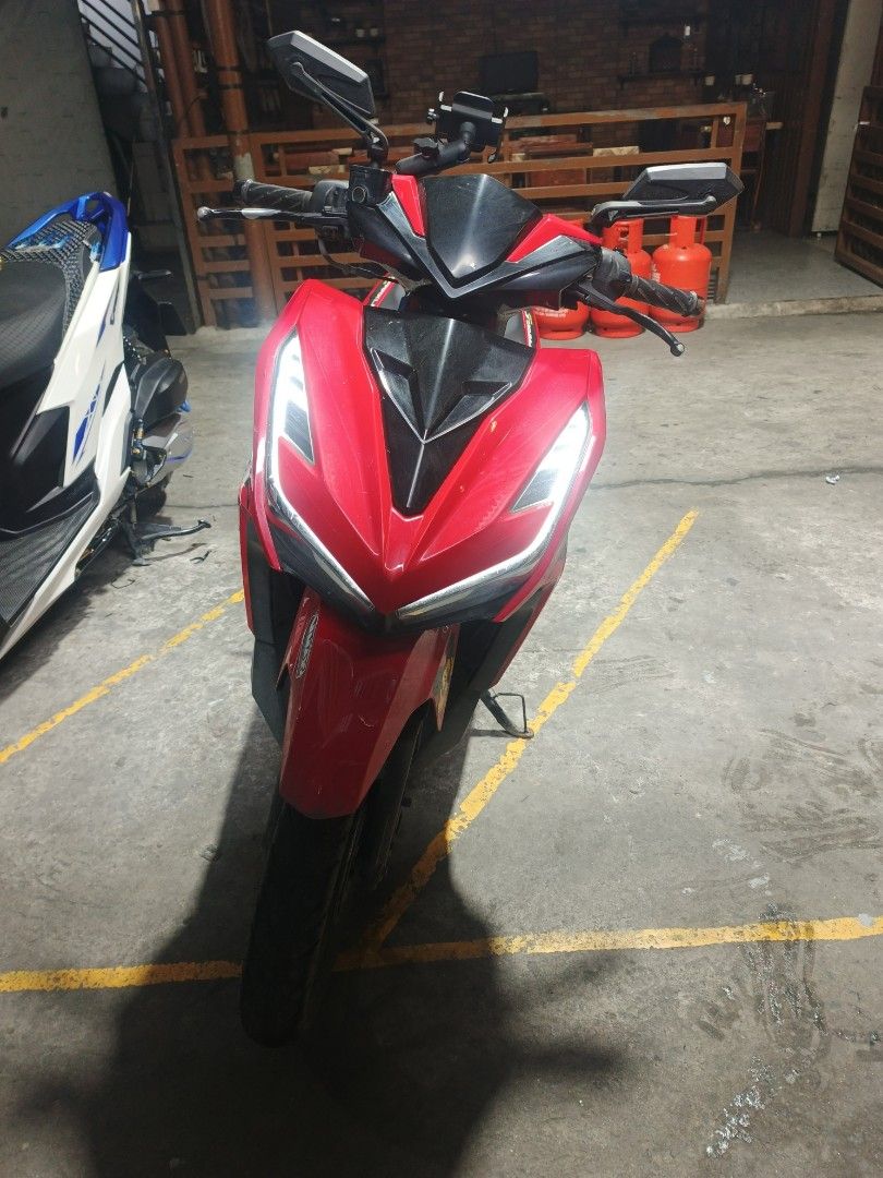 Red Automatic Scooter Motorcycle (Category: Motorbikes for Sale) located in Manila. Submitted by pieces1996 (Listing ID 1465897876, Image 3). Description: Bright red automatic scooter. Black seat and floorboards. Custom F1 and Vmax stickers on the front fairing. Sharp angular headlight design with LED strips. Side mirrors installed on the handlebars. Alloy wheels with black finish. Clean body panels and standard handlebar grips..
