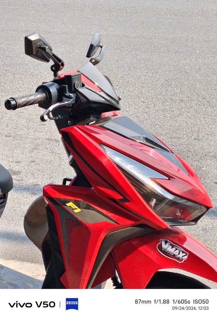 Red Automatic Scooter Motorcycle (Category: Motorbikes for Sale) located in Manila. Submitted by pieces1996 (Listing ID 1465897876, Image 2). Description: Bright red automatic scooter. Black seat and floorboards. Custom F1 and Vmax stickers on the front fairing. Sharp angular headlight design with LED strips. Side mirrors installed on the handlebars. Alloy wheels with black finish. Clean body panels and standard handlebar grips..