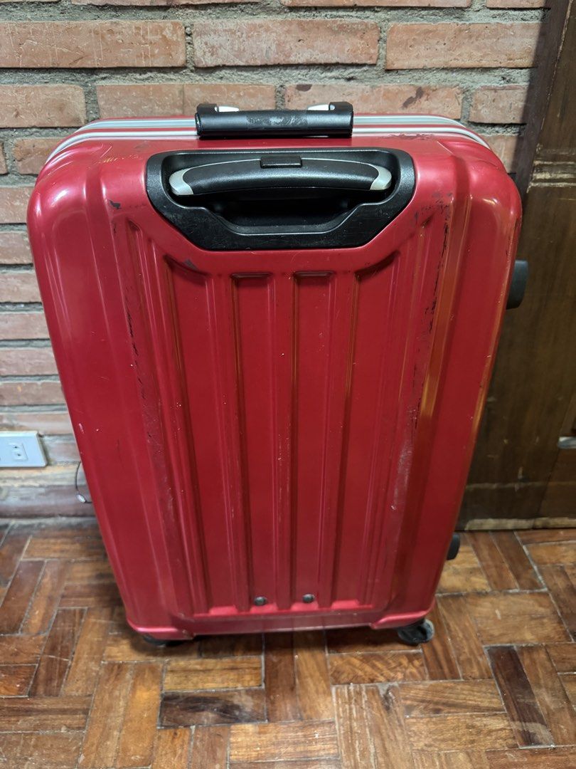 Red hardside spinner suitcase with stripe interior (Category: Luggage) located in Quezon City. Submitted by twinklefindsph (Listing ID 1465786770, Image 2). Description: - Vibrant red hardside suitcase featuring modern vertical grooves - Secure zipperless design with built-in side combination locks - Smooth 4-wheel spinners for effortless mobility - Retractable top handle and convenient side carry handle - Stylish blue and white striped interior 