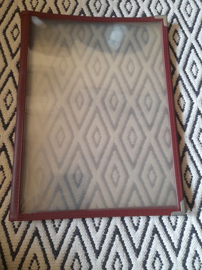 Red Leatherette Menu Cover with Clear Plastic Sleeves (Category: Stationery & School Supplies) located in Bocaue. Submitted by marajapansurplus (Listing ID 1465800248, Image 1). Description: - Color & Material: Elegant burgundy faux leather - Durability: Silver metal corner protectors on front and back - Display: Multiple clear plastic view panels for menus or price lists - Ideal For: Restaurants, cafes, and bars - Condition: Cleaned, practical, 