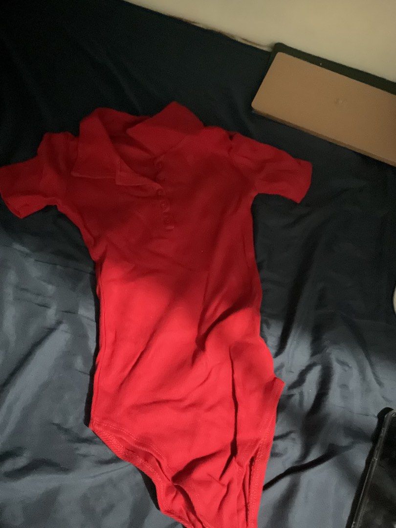 Red Short Sleeve Polo Bodysuit (Category: Blouses) located in Manila. Submitted by _khaori (Listing ID 1465789412, Image 1). Description: - Color: Bright red - Style: Polo collar with button placket and short sleeves - Fabric: Comfortable ribbed texture - Closure: Convenient snap closure at the bottom - Condition: Clean and well-maintained - Styling tip: Perfect to match with high-waisted jeans or skirts.