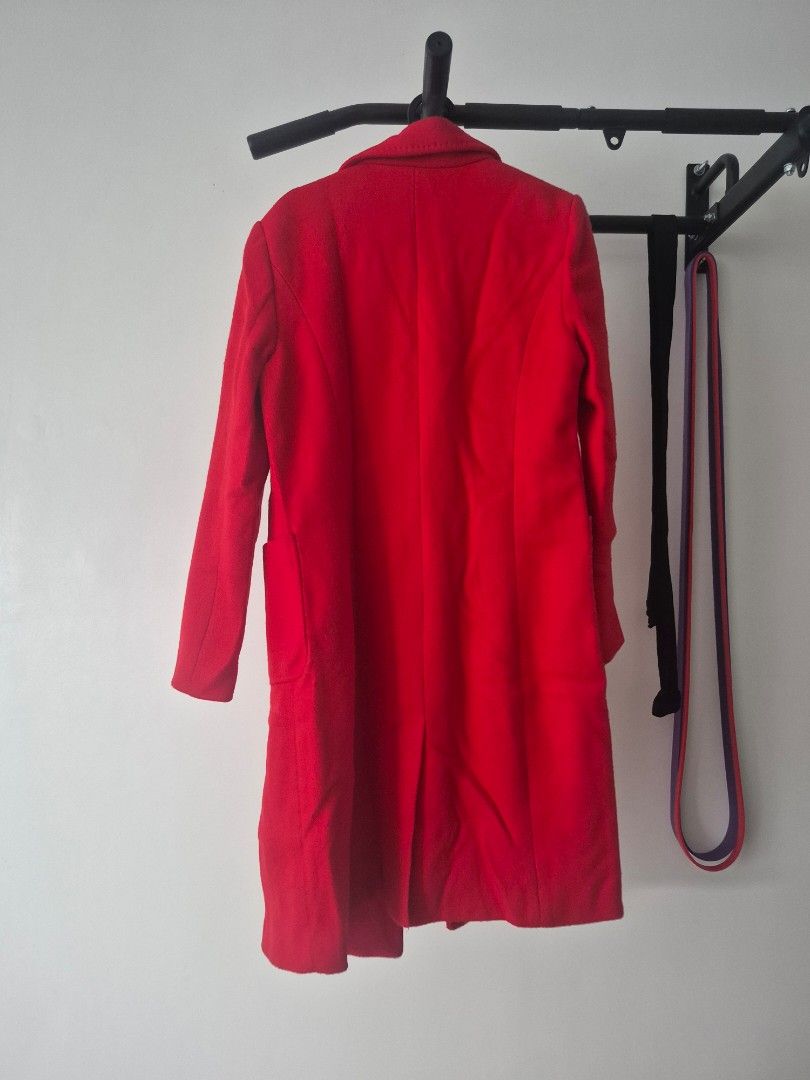 Red wool coat double breasted (Category: Coats, Jackets and Outerwear) located in Paranaque City. Submitted by decluttering.pque (Listing ID 1465847544, Image 2). Description: Used once only Dry cleaned Fits medium frames - Color: Bright red with dark buttons - Style: Double-breasted with lapel collar and front pockets - Lining: Fully lined - Fit & Fabric: Structured fit, thick material for cold weather - Condition: Clean overall.