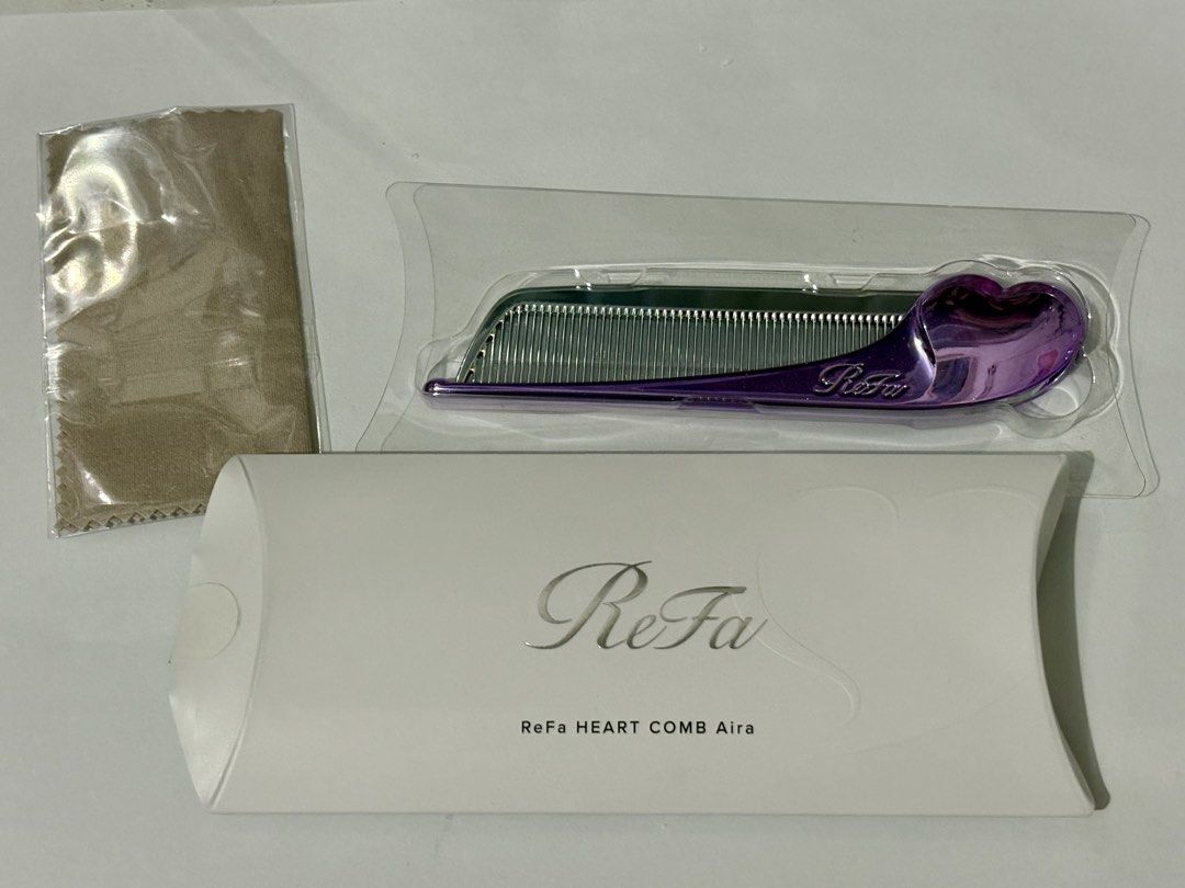 ReFa HEART COMB Aira M Purple (Category: Hair Accessories) located in General Trias. Submitted by perikok0 (Listing ID 1465829608, Image 1). Description: - Model: ReFa Heart Comb Aira in M Purple - Design: Cute heart-shaped handle with a stylish metallic finish - Benefits: Keeps hair smooth, shiny, and tangle-free - Portability: Compact size, easily fits in any handbag for on-the-go touch-ups - Inclusions: Comes with original white packaging box 
