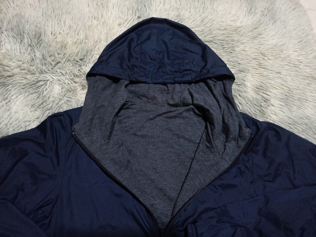 Reversible Blue and Grey Hooded Jacket (Category: Coats, Jackets and Outerwear) located in Alaminos. Submitted by aj_collection28 (Listing ID 1465950223, Image 3). Description: - 2-in-1 reversible design: solid blue nylon on one side, grey heathered knit on the other -Size: Small - Color: Navy Blue -Dimes: 20.5W x 24L - Functional pockets available on both sides - Drawstring hood for an adjustable, comfortable fit - Lightweight material, ideal fo
