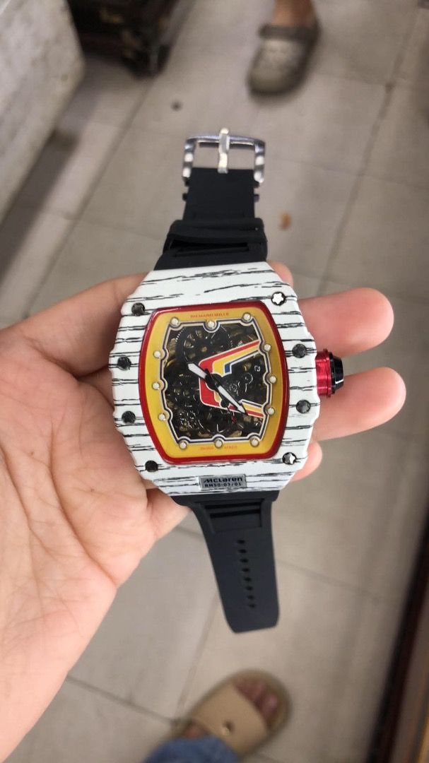 Richard Mille Watch with Box (Category: Luxury Watches) located in Caloocan City. Submitted by mrbigdreams (Listing ID 1465778775, Image 2). Description: - Model: Richard Mille luxury wristwatch - Design: Striking white patterned case with bold yellow and red dial accents - Strap: Comfortable black rubber strap - Movement: Stylish skeleton dial design - Inclusions: Comes with original branded presentation box and protective pouch - Condition: Bra