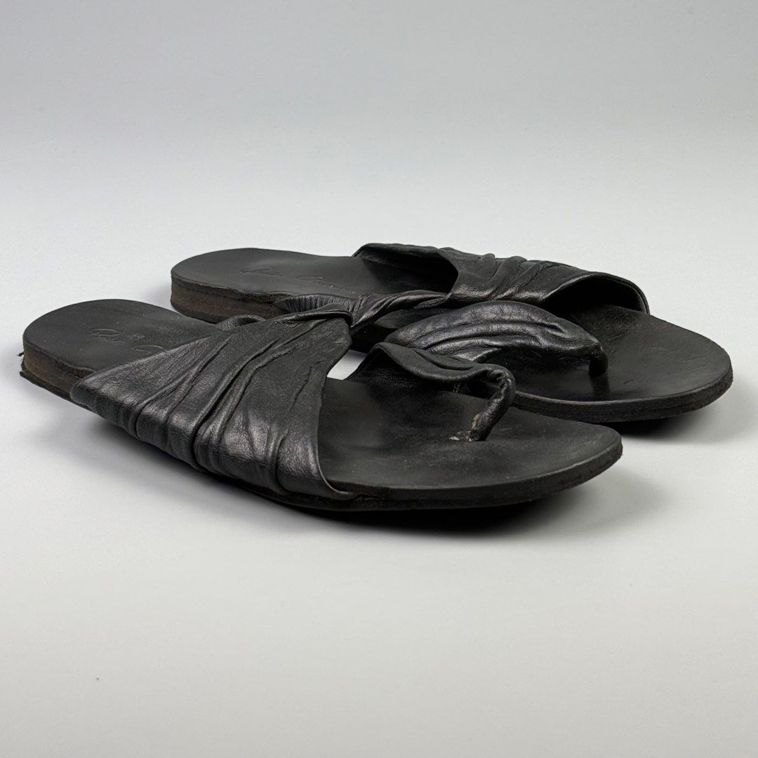 Rick Owens - Twisted Leather Sandals (Category: Sandals) located in Pasig City. Submitted by on_the_trend (Listing ID 1465790903, Image 1). Description: Tagged size: 36 Condition: 8/10 Flaws: Overall minor scuffs, Frayed toe loop, Drags Made in: Italy Inclusion: None .