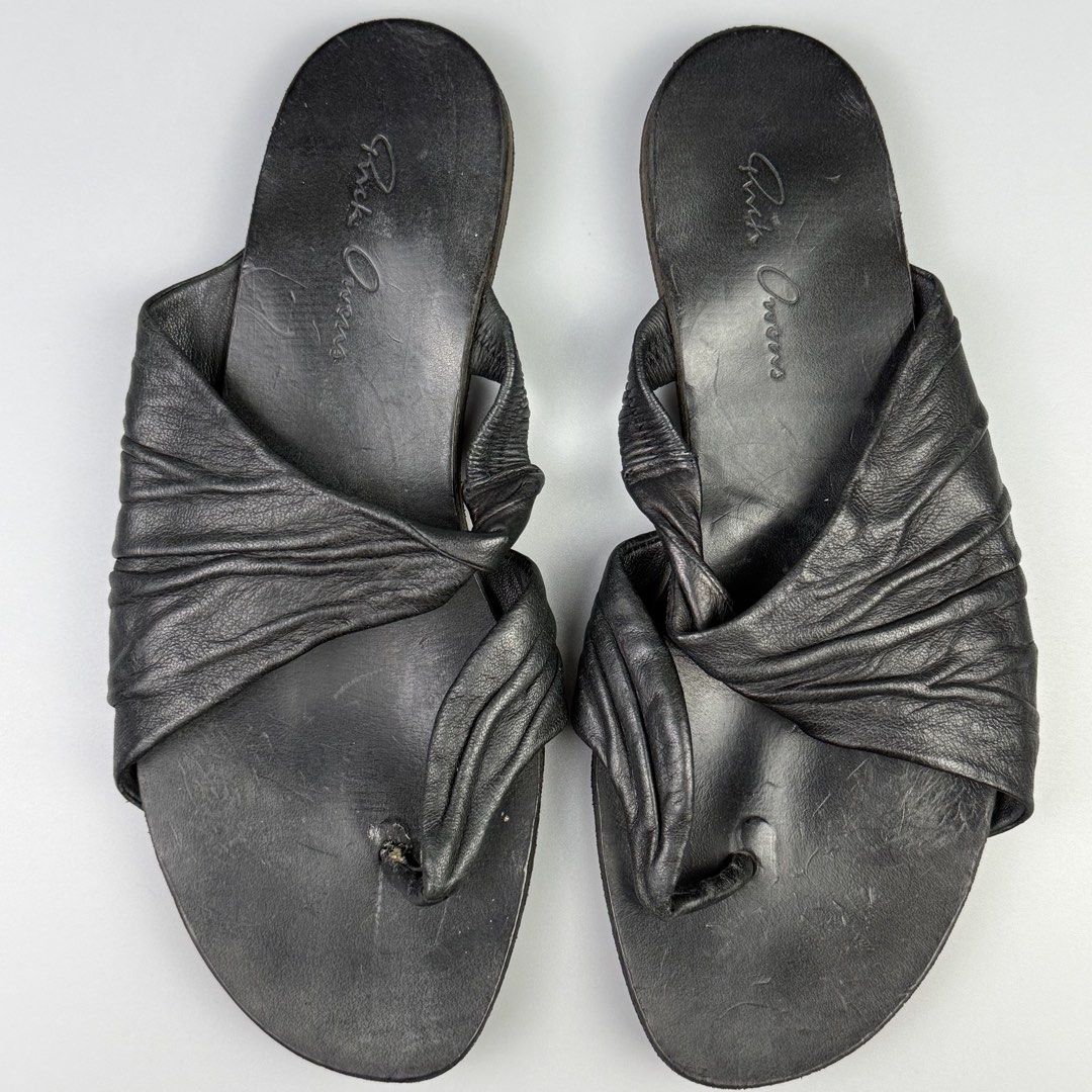 Rick Owens - Twisted Leather Sandals (Category: Sandals) located in Pasig City. Submitted by on_the_trend (Listing ID 1465790903, Image 2). Description: Tagged size: 36 Condition: 8/10 Flaws: Overall minor scuffs, Frayed toe loop, Drags Made in: Italy Inclusion: None .