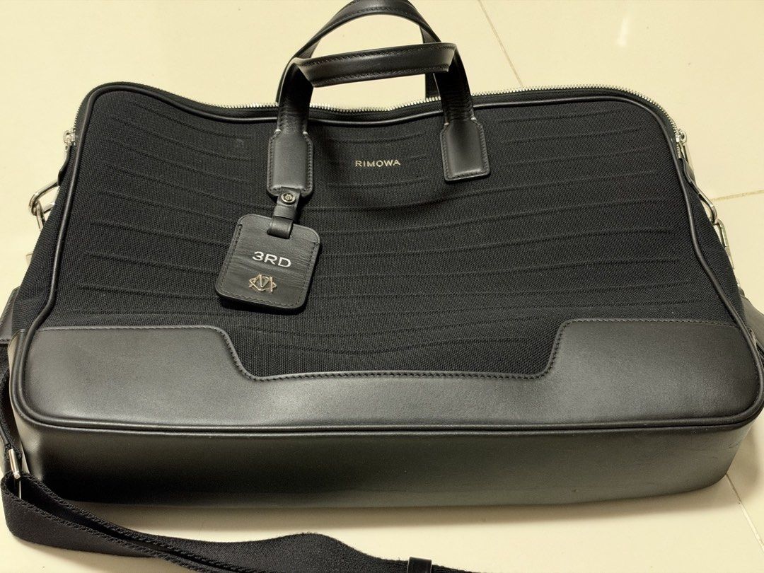 Rimowa Never Still Briefcase Black (Category: Briefcases) located in Pasig City. Submitted by hshmt (Listing ID 1465882176, Image 1). Description: - Brand: Rimowa Never Still Briefcase - Color: Black - Material: Durable fabric body with sturdy leather handles and silver-tone hardware - Closure: Secure zipper closure - Provenance: Purchased recently from Travel with the Grooves, Shangri-La Plaza - Inclusions: Original receipt and store papers incl