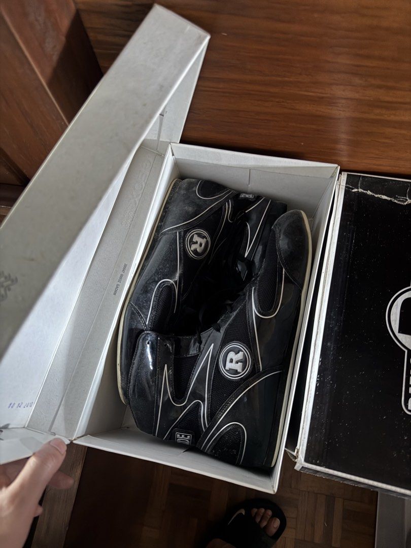 Ringside Black High Top Sneakers with Box (Category: Sneakers) located in Manila. Submitted by seangoart (Listing ID 1465765804, Image 1). Description: - Brand: Ride - Color: Black with white piping details - Design: Prominent circular R logo on the sides - Material: Glossy patent leather and mesh fabric mix - Features: Lace-up style with comfortable padded ankle support - Inclusions: Original white shoebox included - Condition: Excellent / Ready