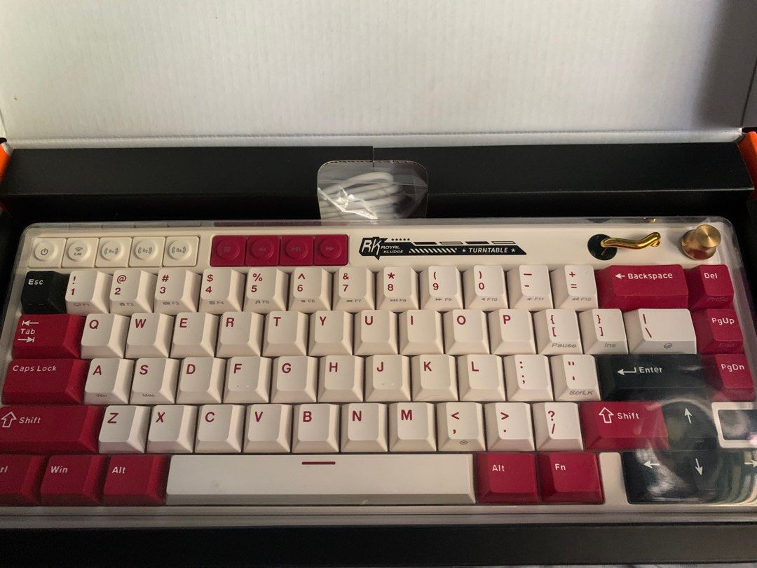 RK Royal Kludge M65 Mechanical Keyboard (Category: Computer Keyboard) located in San Mateo. Submitted by mattoramirez (Listing ID 1465831023, Image 3). Description: - Model: RK M65 mechanical keyboard - Colorway: White and red - Layout: Compact with volume knob and media keys - Condition: Clean and fully functional (used only once) - Inclusions: Original box, USB-C cable, keycap puller, and extra switches - Perfect for: Gaming and typing setups C