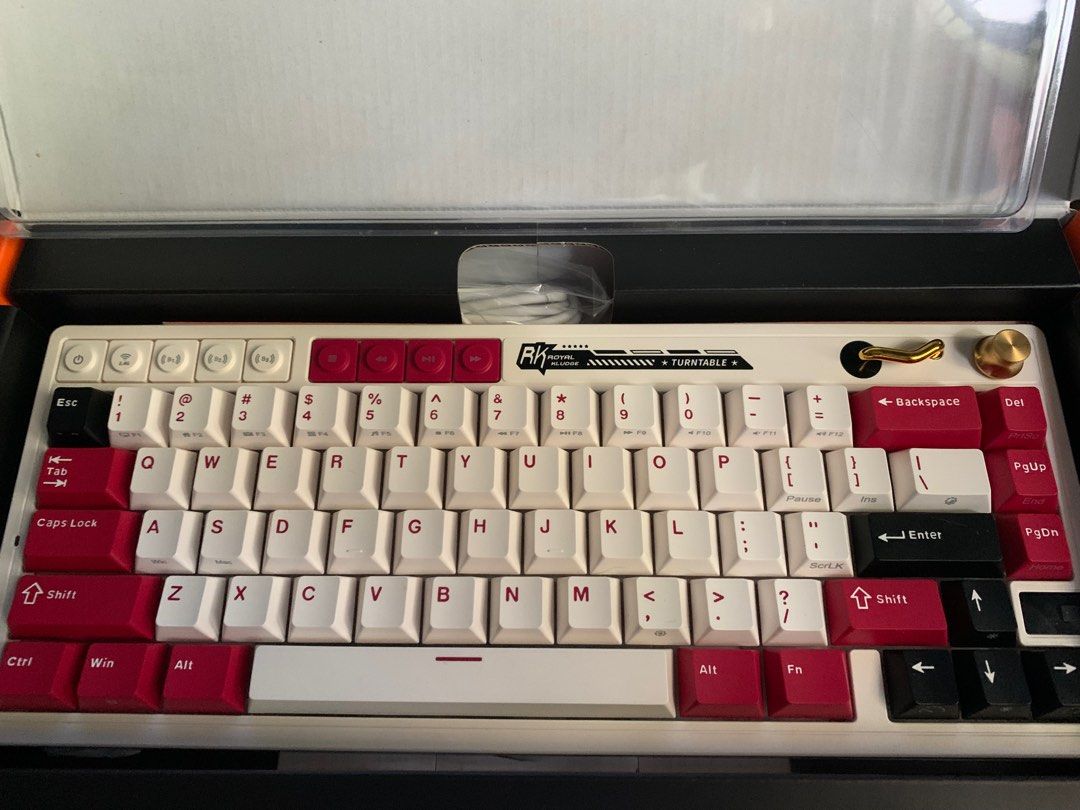RK Royal Kludge M65 Mechanical Keyboard (Category: Computer Keyboard) located in San Mateo. Submitted by mattoramirez (Listing ID 1465831023, Image 2). Description: - Model: RK M65 mechanical keyboard - Colorway: White and red - Layout: Compact with volume knob and media keys - Condition: Clean and fully functional (used only once) - Inclusions: Original box, USB-C cable, keycap puller, and extra switches - Perfect for: Gaming and typing setups C