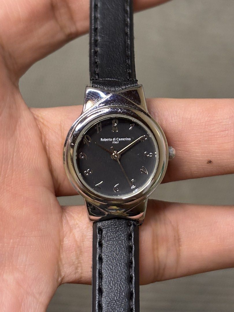 Roberta di Camerino Bow Lug Quartz (Category: Women's Watches) located in Manila. Submitted by soughtafterseconds (Listing ID 1465793723, Image 1). Description: Roberta di Camerino Bow Lug Quartz This Roberta di Camerino Sculpted Bow-Lug Quartz Watch is a stylish piece of Italian fashion horology, featuring an integrated bow/ribbon lug structure paired with a minimal dark dial face. Founded in Venice, Italy, in 1945 by Giuliana Coen (who adopted 