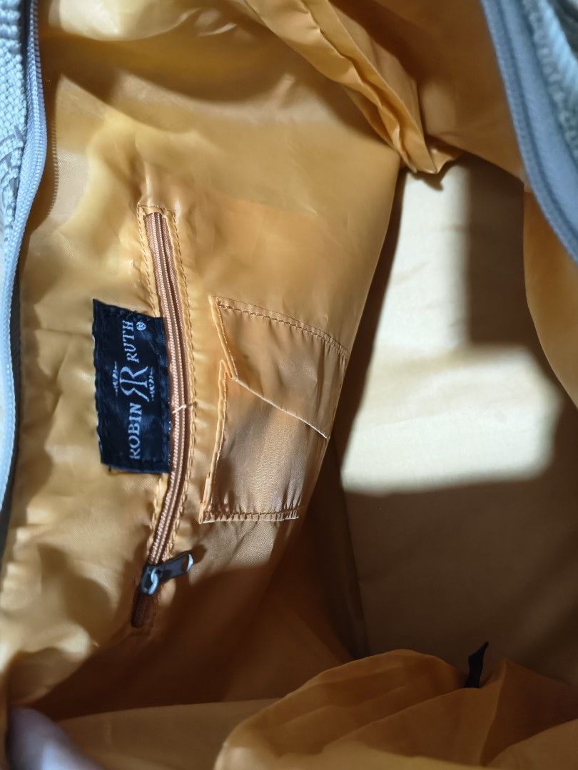 Robin Ruth Venezia Shoulder Bag (Category: Shoulder Bags) located in Tarlac. Submitted by momma02 (Listing ID 1465770310, Image 3). Description: - Brand: Robin Ruth Venezia - Style: Hobo shoulder bag - Exterior: Textured fabric with bold yellow and brown city typography print - Details: Round branded metal tag on the strap - Closure: Top zip closure - Interior: Bright yellow lining with one zippered pocket and one slip pocket - Condition: Unused,
