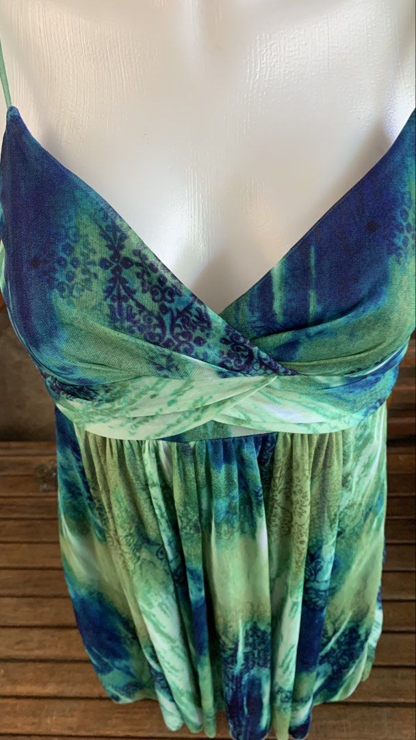 Ruby Rox Blue Green Tie Dye Dress Size S (Category: Dresses) located in Manila. Submitted by thriftnivee (Listing ID 1465782406, Image 2). Description: - Brand: Ruby Rox (Tag attached) - Size: Small - Color/Pattern: Blue and green tie dye - Neckline: V-neck with twisted fabric detail - Straps: Spaghetti straps - Features: Lightweight layered fabric with royal blue lining and adjustable back tie sash -size bust 35 waist 26.