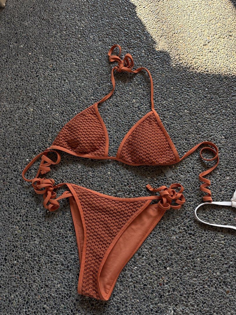 Rust Orange Textured Triangle Bikini Set Size M (Category: Bikinis & Swimsuits) located in San Fernando. Submitted by gigikyla (Listing ID 1465925233, Image 1). Description: - Color: Rust orange - Material/Texture: Crochet-textured knit - Top: Triangle style with halter neck ties and adjustable strings - Bottom: Matching tie-side design - Size: M (tag attached) - Condition: Brand new with tag, great for beach days or pool lounging.
