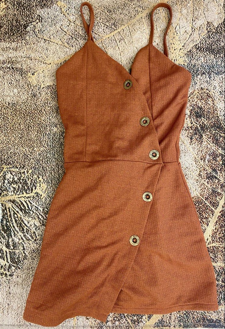 Rust Orange V-Neck Cami Mini Dress with Buttons (Category: Dresses) located in Manila. Submitted by ariane0422 (Listing ID 1465929938, Image 1). Description: - Color: Rust orange - Style: Mini dress with thin shoulder straps and V-neckline - Design: Asymmetrical wrap-style skirt with rustic metallic buttons diagonally down the front - Fabric: Lightweight textured material, great for warm weather - Condition: Excellent, clean with no flaws noticed