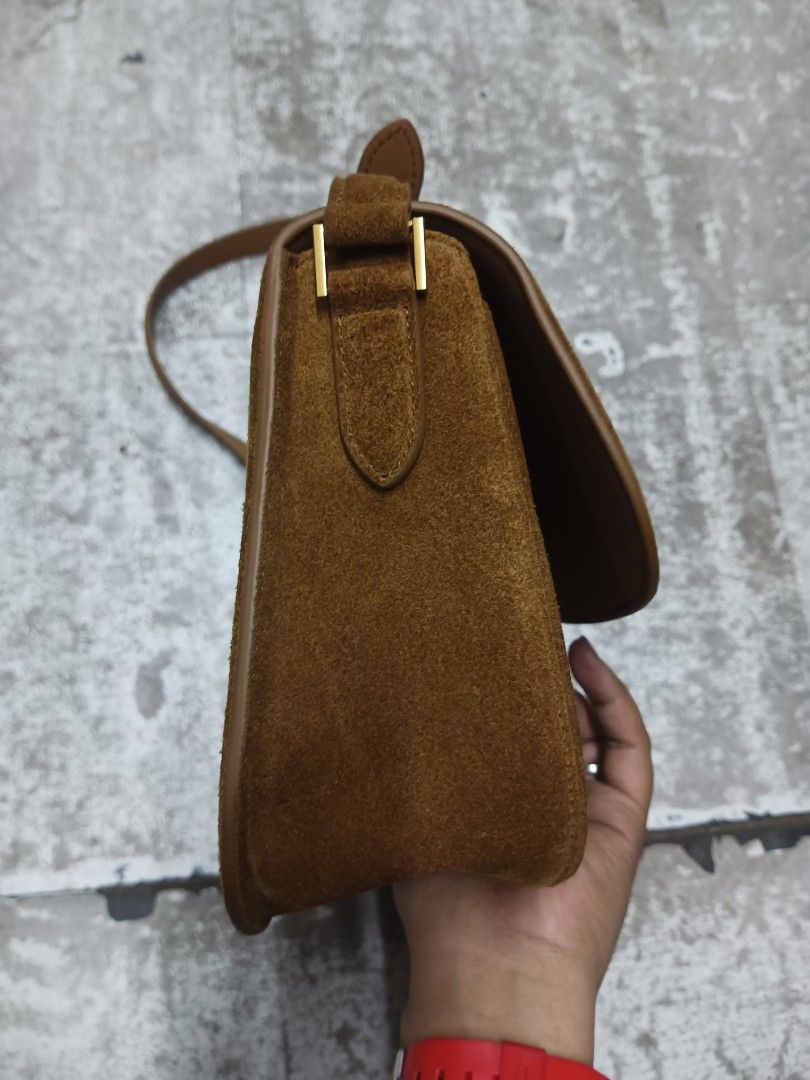Saint Laurent Solferino Suede Shoulder Bag (Category: Luxury Bags & Wallets) located in Baguio. Submitted by brandeditems16 (Listing ID 1465834753, Image 3). Description: - Brand: Saint Laurent - Material: Premium brown suede - Hardware: Gold-tone - Design: Classic saddle silhouette -Dust with iconic front flap YSL monogram - Strap: Adjustable with buckle closure - Interior: Clean lining with a convenient zipper pocket - Condition: Well-maintaine