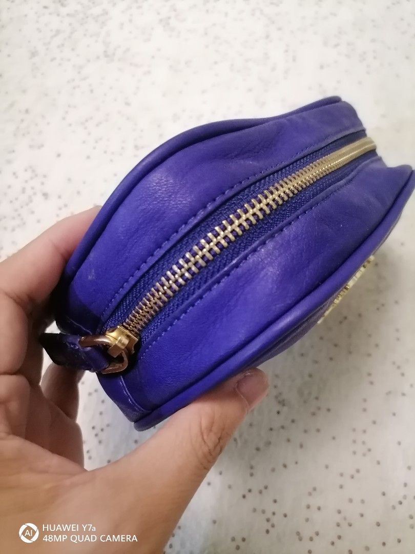 Salad blue leather cosmetic pouch (Category: Purses & Pouches) located in Naga. Submitted by mrwisethrifter (Listing ID 1465829596, Image 3). Description: - Brand: Salad - Color: Electric blue - Material: Smooth leather-feel finish - Hardware: Gold-tone with front logo and ribbon emblem - Closure: Fully zipped top - Use: Compact size, ideal for makeup or small daily essentials.