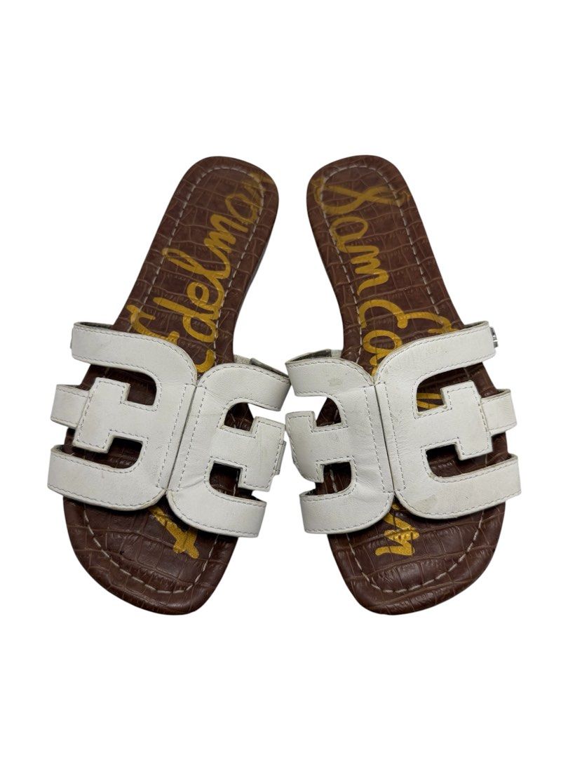 Sam Edelman (Category: Sneakers & Footwear) located in Baguio. Submitted by jerome09965737 (Listing ID 1465950328, Image 1). Description: - Brand: Sam Edelman - Style: Slip-on slide sandals - Color/Material: White leather cut-out straps with brown croc-embossed footbed - Details: Gold logo print on footbed, flat sole with textured tread - Condition: Normal wear on straps and soles, plenty of life left - Perfect for: Quick, stylish warm-weather ou